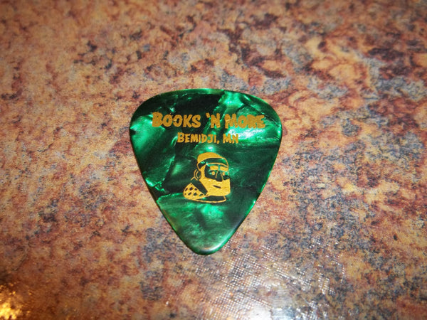 Guitar Pick Medium Celluloid - Paul Bunyan Books N More - Gold on Green Pearl Plastic